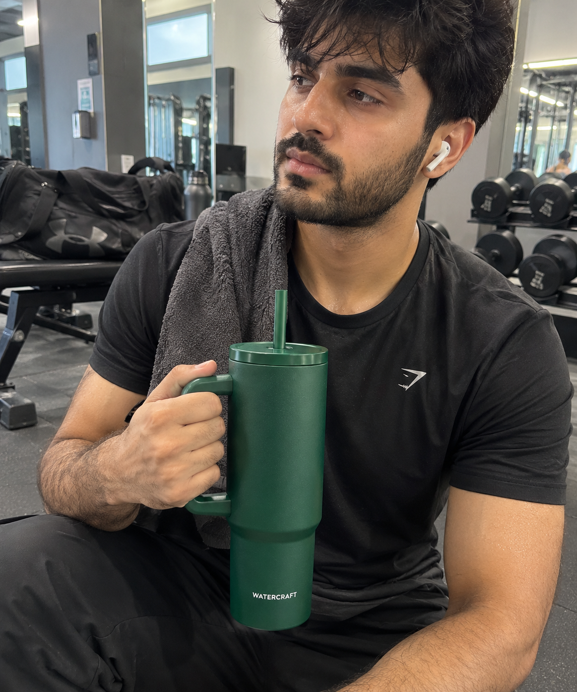 Man carrying WaterCraft Aura green tumbler at the gym - UGC